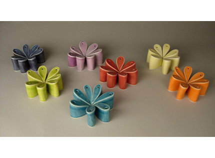 seven sets of seven bud vases, in the shape of stylized daisy petals